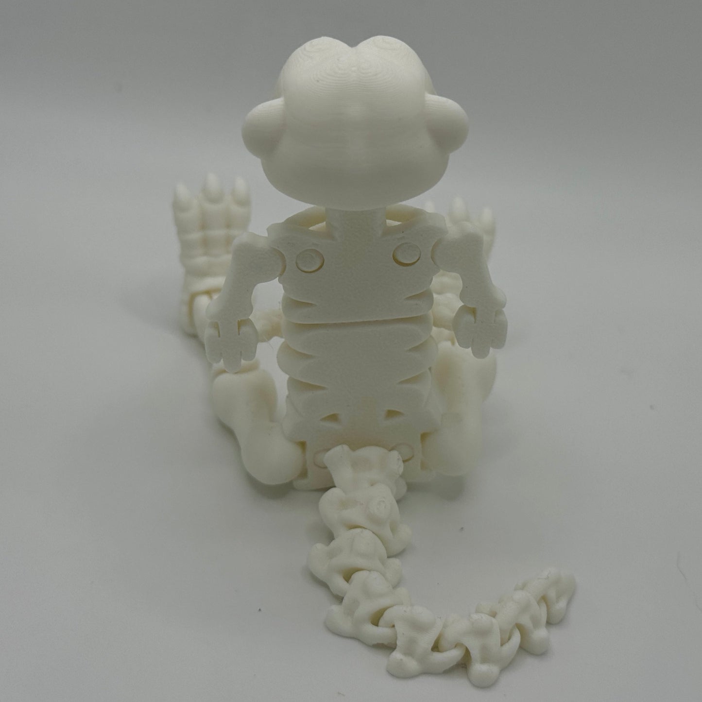 White 3D-printed skeleton model on a gray background