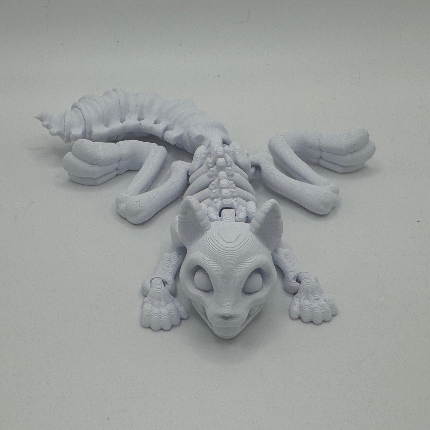 Gray 3D-printed creature on a light gray background