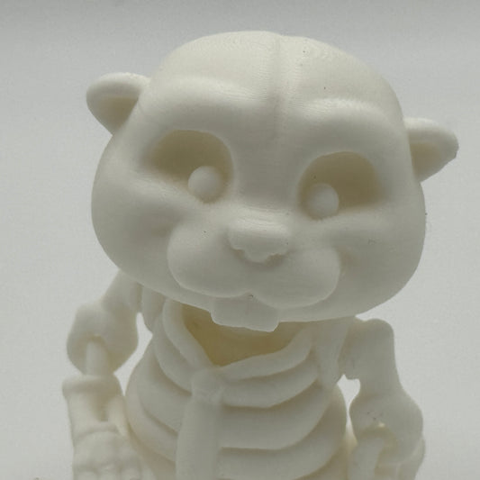 White 3d printed plastic  beaver skeleton figurine on a gray background