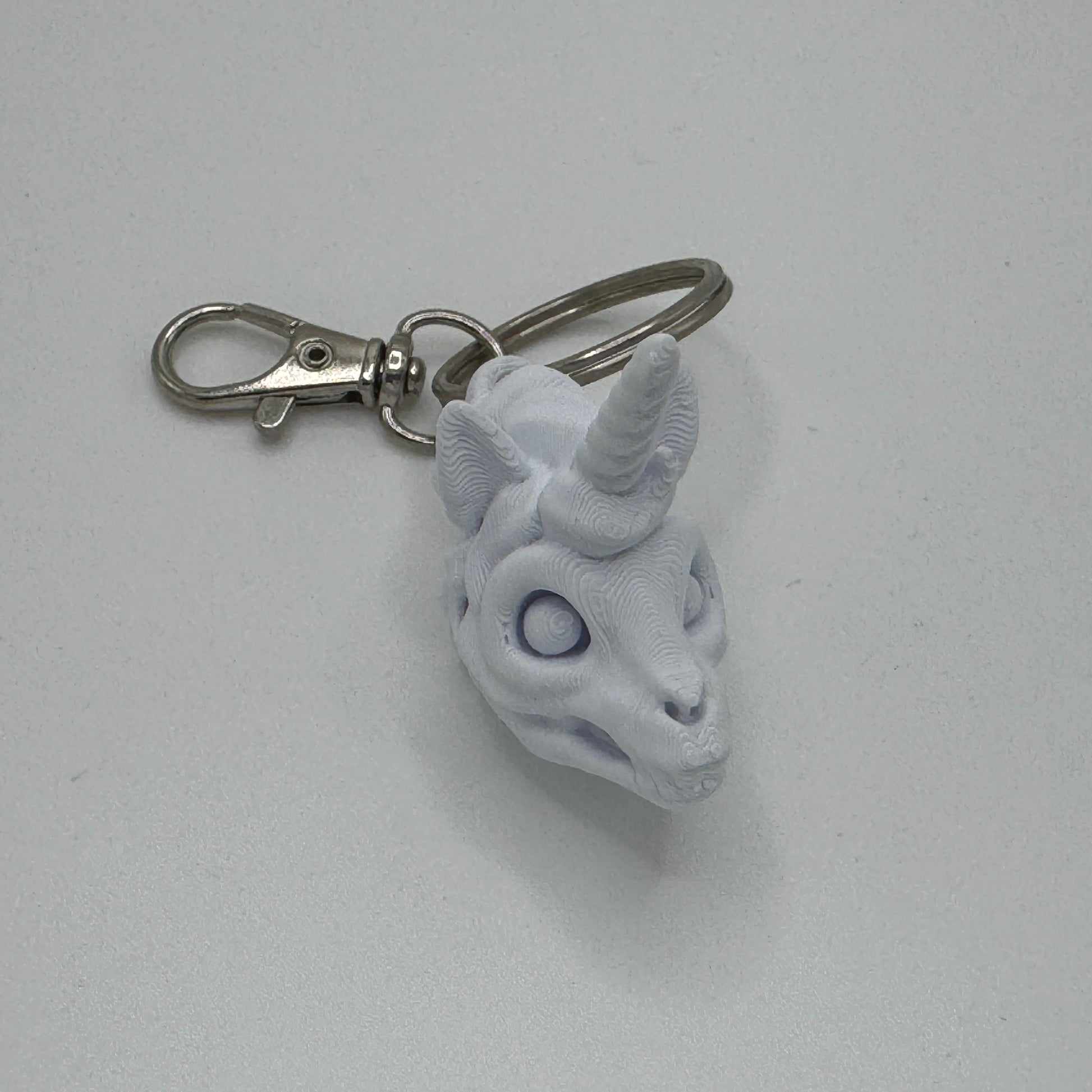 Keychain with a unicorn head design on a white background